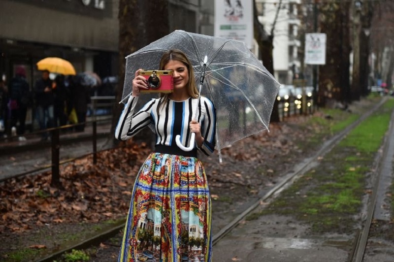 A guest poses in the street before the show for fashion house Dolce & Gabbana. u00e2u20acu2022 AFP pic