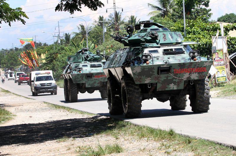 Military armoured personnel carriers patrolling a highway in Mindanao, May 13, 2013. This area in the southern Philippines is a well-known hotbed of Abu Sayyaf activities. u00e2u20acu201d AFP pic 
