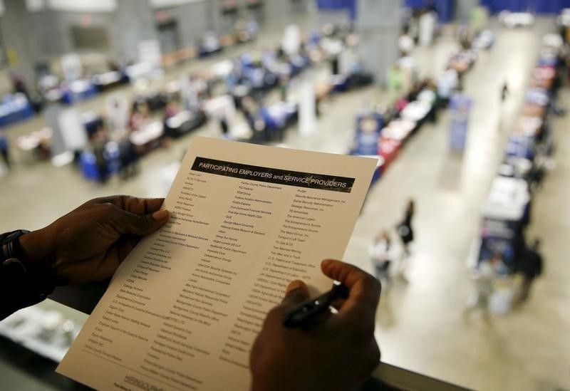 A job seeker looks over his choice of firms that are interviewing at a US Chamber of Commerce Foundation u00e2u20acu02dcHiring Our Heroesu00e2u20acu2122 military job fair in Washington January 8, 2016. REUTERS/Gary Cameron