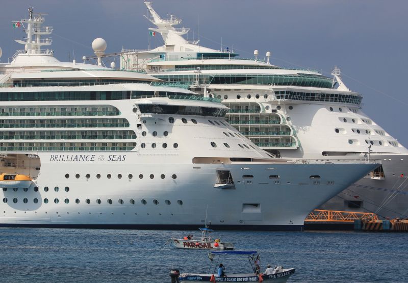 The Royal Caribbeanu00e2u20acu2122s Brilliance of the Seas cruise ship (L) in Cozumel, Mexico, March 19, 2016, after it had picked up Cuban migrants off the Florida coast, handing them over to Mexican immigration officers. REUTERS/Stringer