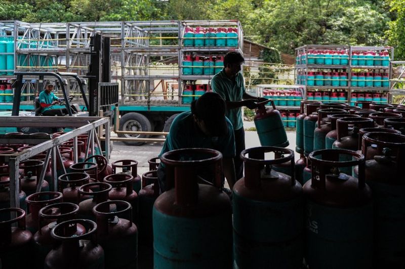 Workers arrange refilled Petronas gas cylinders at a shop in Ampang, Kuala Lumpur. Picture released  March 1, 2016. u00e2u20acu2022 AFP pic