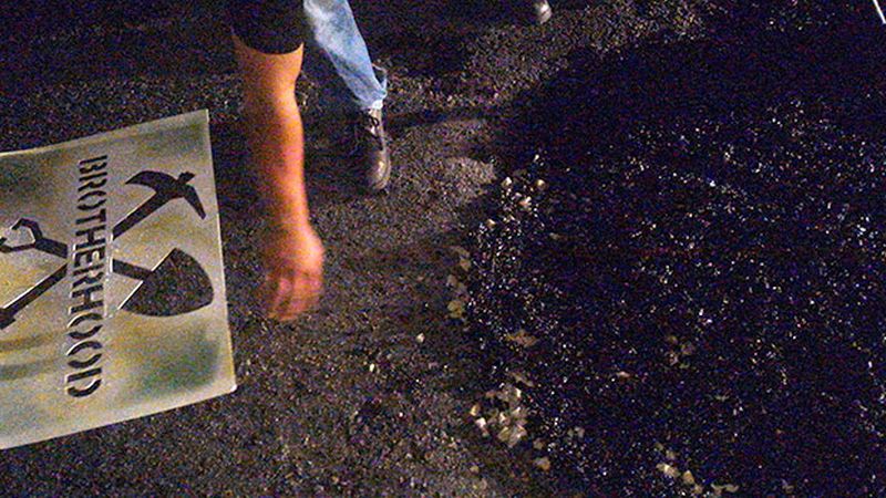 Once they are done fixing a pothole, members of the Brotherhood spray their logo on it.