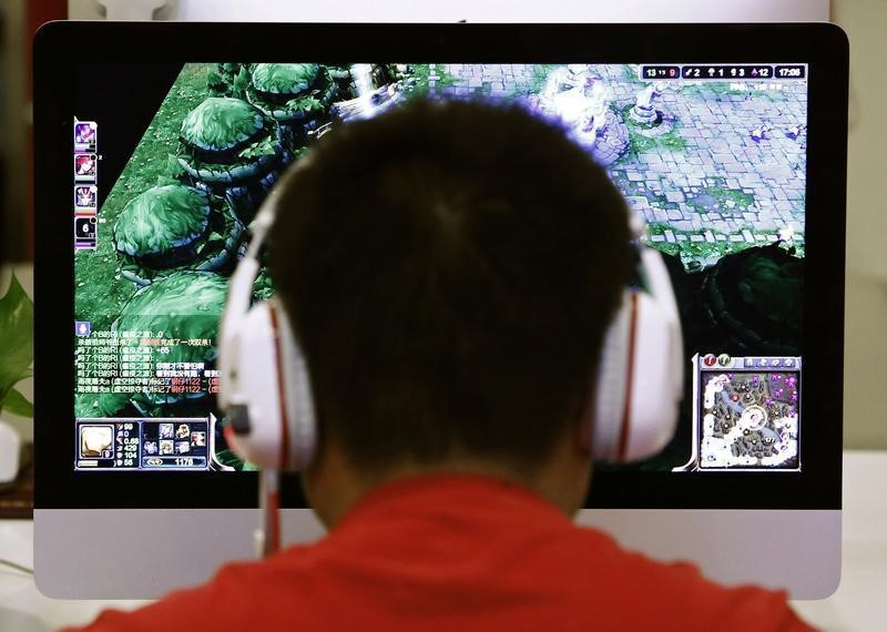 A man plays a computer game at an internet cafu00c3u00a9 in Beijing in this May 9, 2014 file photo. u00e2u20acu201d Reuters pic