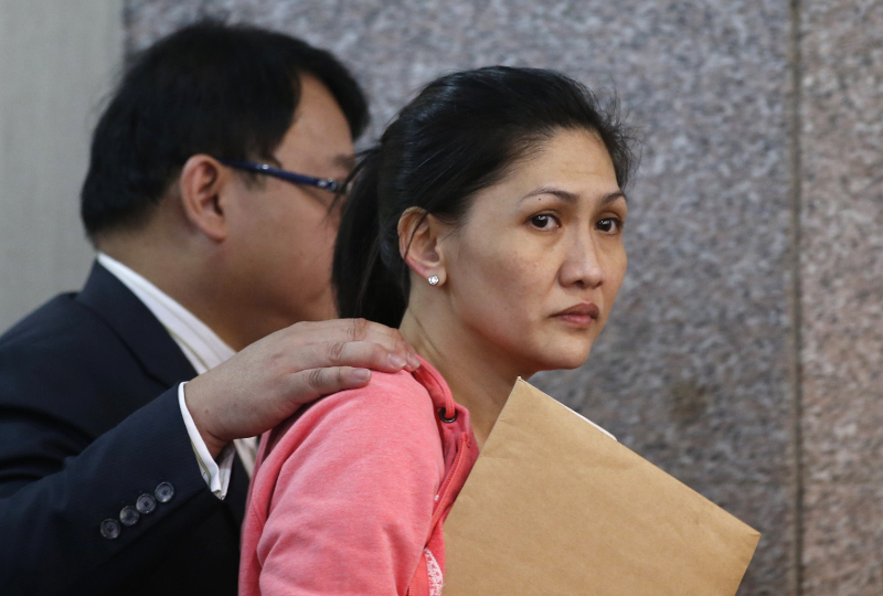 Maia Santos Deguito (right), a branch manager of the Rizal Commercial Banking Corp (RCBC) is escorted by her lawyer after testifying at a Philippine Senate in Manila, Philippines March 17, 2016. u00e2u20acu201d Reuters pic
