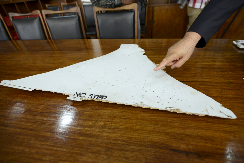 The head of Mozambique's Civil Aviation Institute, Comandante Joao Abreu, shows a piece of debris found on a beach that could be from missing Malaysia Airlines flight MH370, in Maputo, March 3, 2016. u00e2u20acu201d Reuters pic