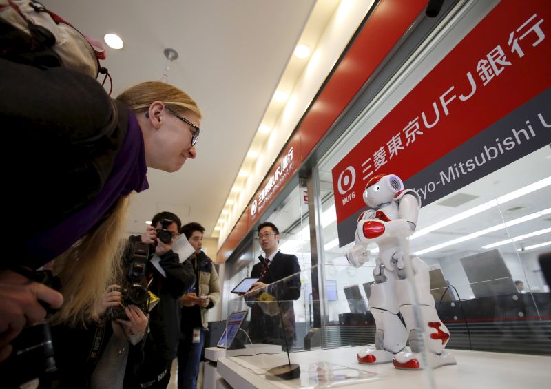 A foreign tourist interacts with u00e2u20acu02dcNaou00e2u20acu2122, a humanoid robot by Aldebaran Robotics that offers basic service information at Narita International airport near Tokyo, Japan. u00e2u20acu2022 Reuters pic