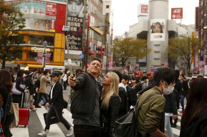A couple takes a selfie at Shibuya junction, which is popular among tourists, in Tokyo, Japan, March 31, 2016. u00e2u20acu2022 Reuters pic
