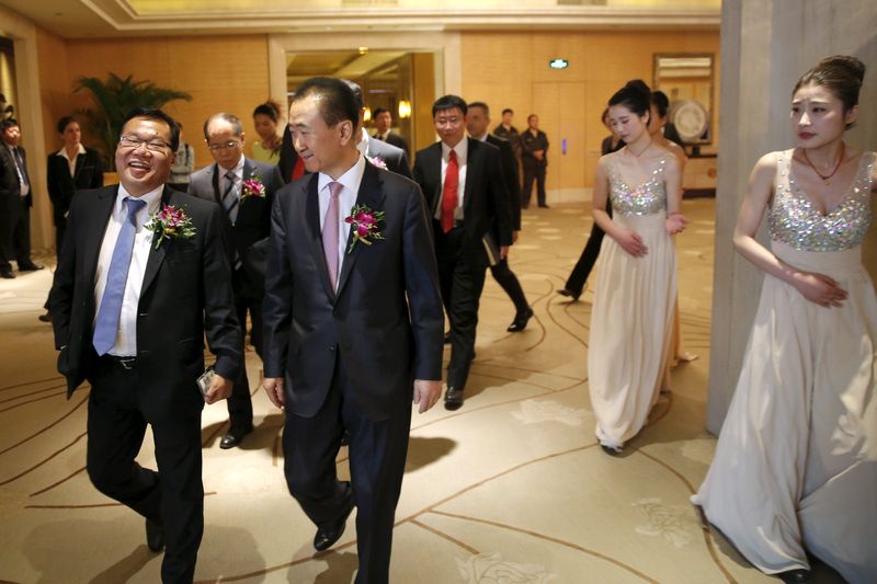 Fifa vice-president David Chung (left) and the chairman of Dalian Wanda Group in China, Wang Jianlin, arrive for a Wanda Group-Fifa event in Beijing March 21, 2016. u00e2u20acu201d Reuters pic