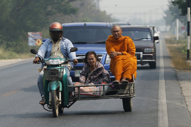 A Buddhist monk rides a motorcycle sidecar on a road in Ratchaburi province, outside Bangkok March 22, 2016. u00e2u20acu201d Reuters picn