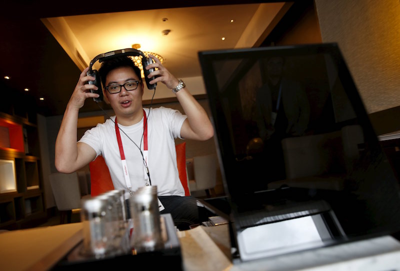 An invited guest enjoys a private listening experience of a test unit of the Sennheiser HE 1 sound system, which is expected to retail for about S$77370, in a hotel suite during the CanJam headphone and personal audio expo in Singapore February 21, 2016. 