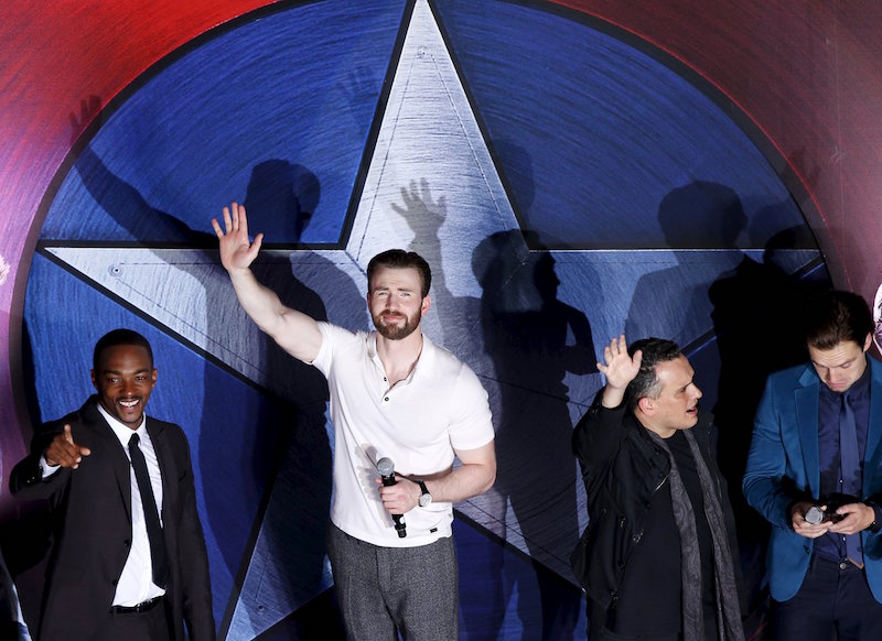 Actors Anthony Mackie, Chris Evans, director Joe Russo and actor Sebastian Stan wave to fans during a blue carpet event for the movie u00e2u20acu02dcCaptain America: Civil Waru00e2u20acu2122 in Singapore April 21, 2016. u00e2u20acu201d Reuters picn