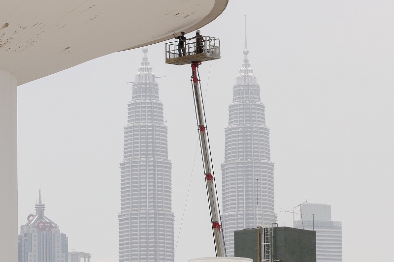 Cuaca panas yang melanda negara sekarang tidak menghalang pekerja-pekerja kontrak mengecat bangunan di Jalan Tun Razak dengan berlatarbelakang bangunan berkembar Petronas di Kuala Lumpur 1 April, 2016. u00e2u20acu201d Foto Bernama