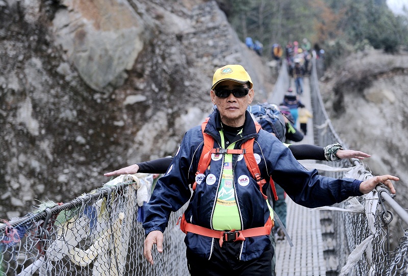 Malaysiau00e2u20acu2122s oldest mountain climber James Lee Chong Meng crosses a bridge as he takes part in the Lions Mount Everest Expedition (MEE) 2016 in Lukla, Nepal April 5, 2016. u00e2u20acu201d Bernama pic