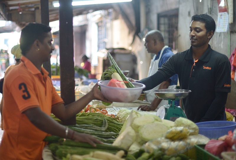 31-year-old Harenthiran Pulingam works at his parent’s wet market stall by day and takes on lead roles in odissi productions by night. — Picture by Razak Ghazali