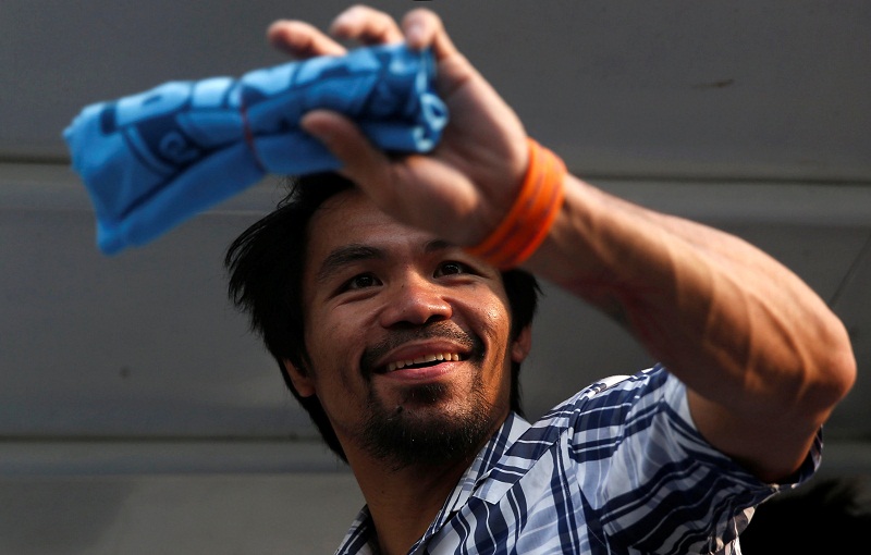 Filipino boxer Manny Pacquiao and Senatorial candidate for May 2016 national elections holds an election souvenir shirt for his supporters during election campaigning for May 2016 national elections in San Pablo, Laguna in the Philippines April 28, 2016. 