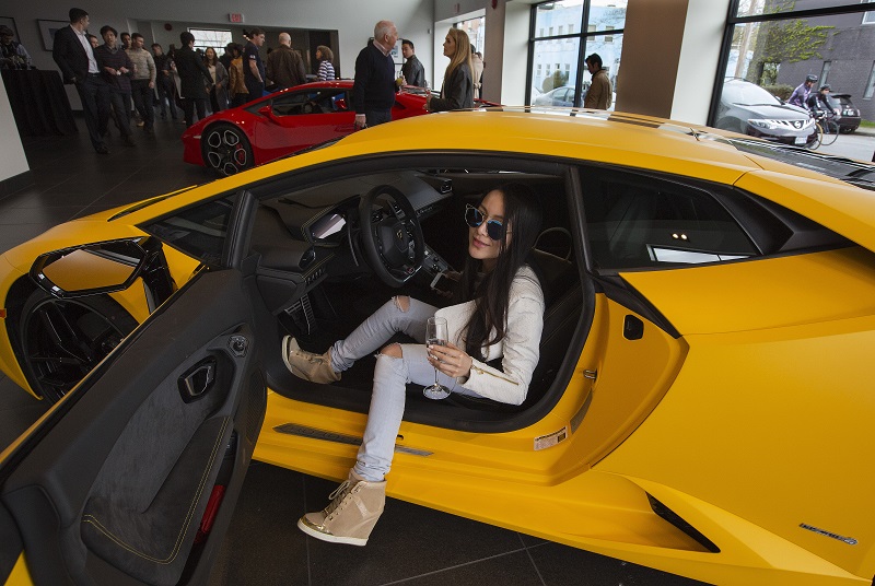 Chelsea Jiang sits in a car while attending a reception at a Lamborghini dealership in Vancouver, British Columbia, March 19, 2016. u00e2u20acu201d Picture by Ruth Fremson/The New York Times