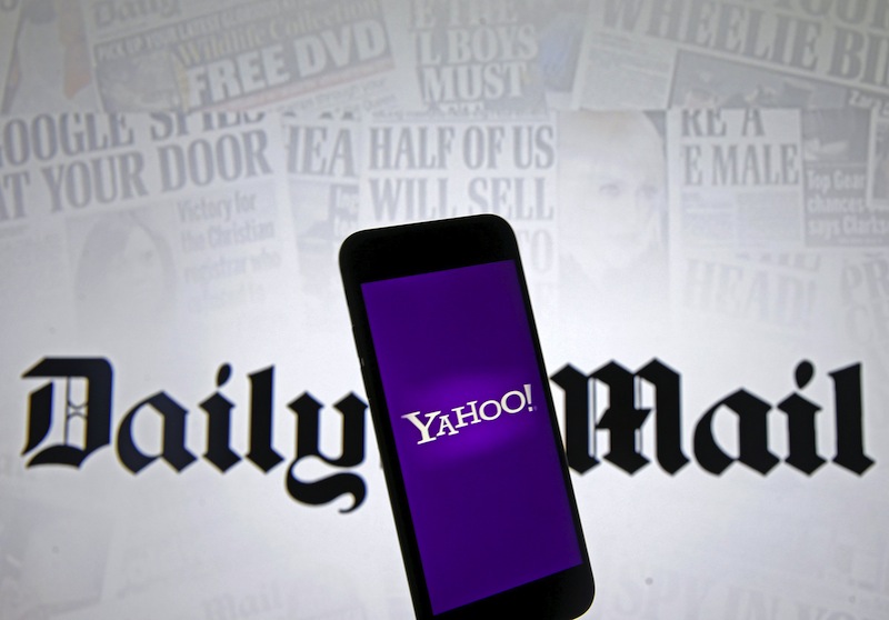 Smartphone with Yahoo logo is seen in front of a displayed Daily Mail logo in this illustration taken April 11, 2016. u00e2u20acu201d Reuters pic