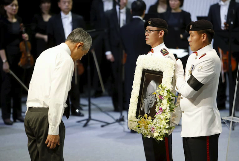 Lee Hsien Loong bows his head in front of a picture of his father Lee Kuan Yew during his funeral at the University Cultural Centre at the National University of Singapore on March 29, 2015. u00e2u20acu201d Reuters pic