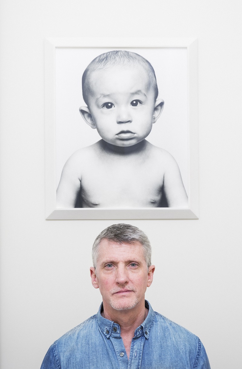 Edward Mapplethorpe stands under a portrait of his son, Harrison, which he shot and included in his new book “One: Sons & Daughters,” at home in New York, April 7, 2016. — Picture by Damon Winter/The New York Times  