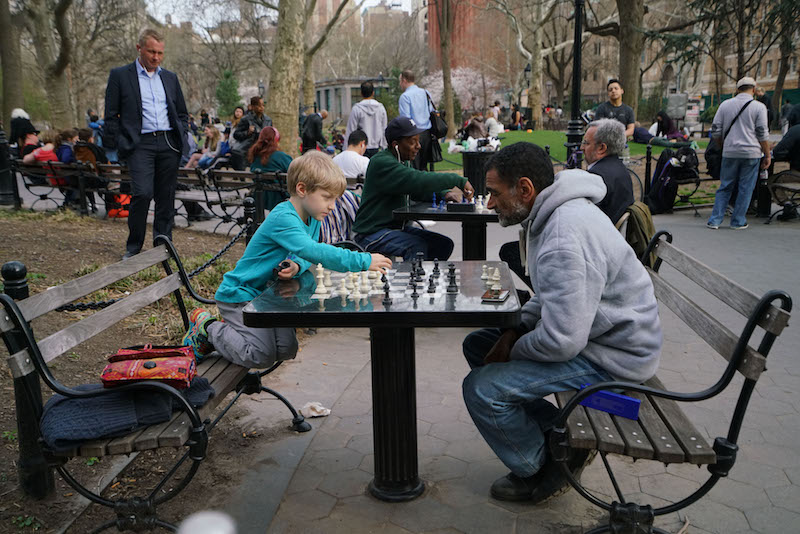 Davin Friedman plays chess with his tutor Abderrahim Rajahi in Washington Square Park, in New York, March 31, 2016. u00e2u20acu201d Picture by Nicole Bengiveno/The New York Times