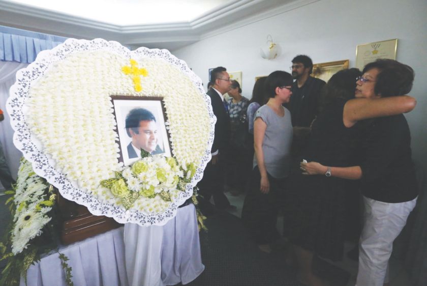 Kristine (right) is hugged by a mourner yesterday. u00e2u20acu201d Pictures by Zuraneeza Zulkifli 