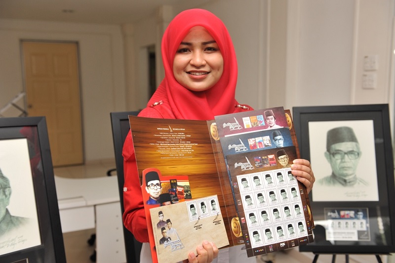 Pos Malaysia staff Adilah Amizan displays the National Laureates stamp collection at the Pos Malaysia Headquarters in Kuala Lumpur, April 26, 2016. u00e2u20acu201d Picture courtesy of Pos Malaysia 