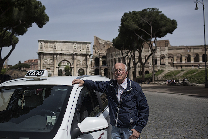 Alberto Tomassi, who has been a taxi driver in Rome for 50 years, with his eighth cab, in front of the Colosseum April 11, 2016. u00e2u20acu201d Picture by Shira Cohen/The New York Timesn