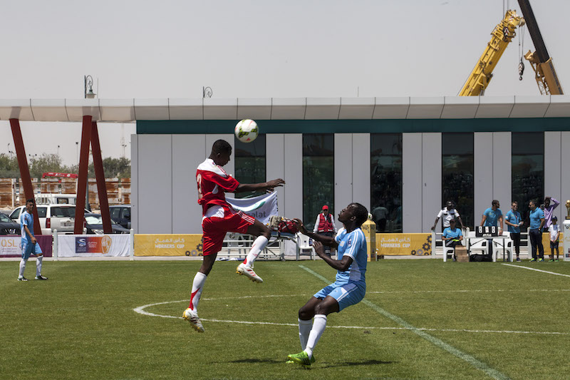 A football match between employees of Gulf Contracting and Mowasalat during the Workers Cup in Doha April 22, 2016. — Picture by Olya Morvan/The New York Times