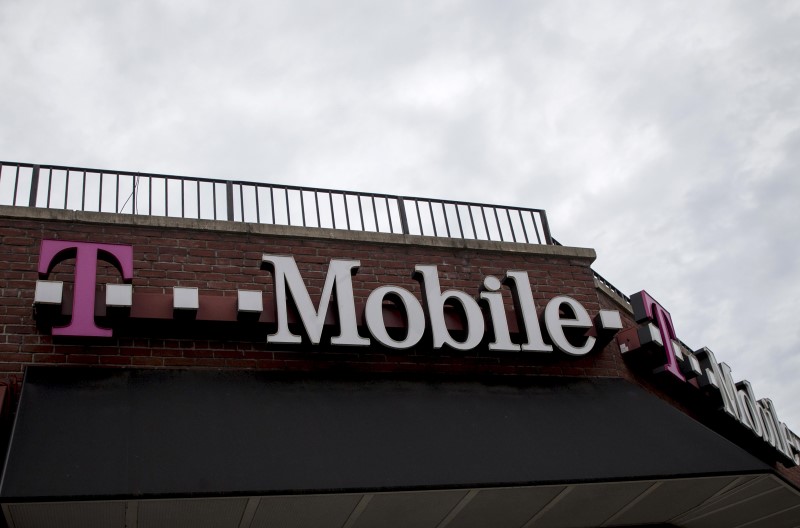 People pass by a T-Mobile store in the Brooklyn borough of New York June 4, 2015. u00e2u20acu201d Reuters pic