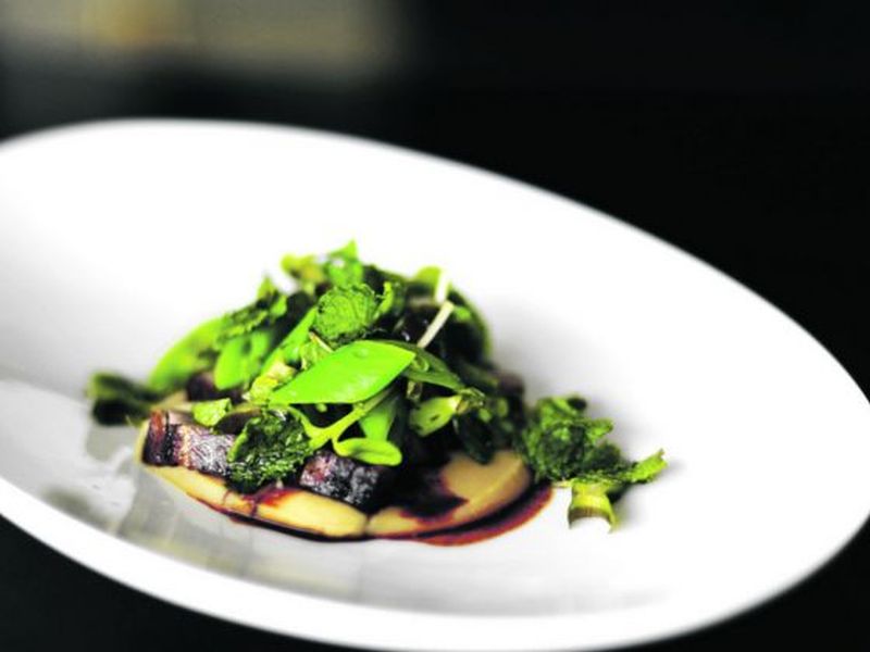 The dish of charred pork on white bean puree celebrates May's Thai roots.