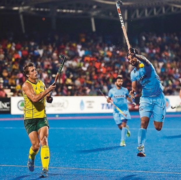 nAustraliau00e2u20acu2122s Craig Thomas scoops the ball past Indian defender Rupinder Pal Singh. Australia won 4-0. u00e2u20acu201d Picture by Farhan Najib Yusoff