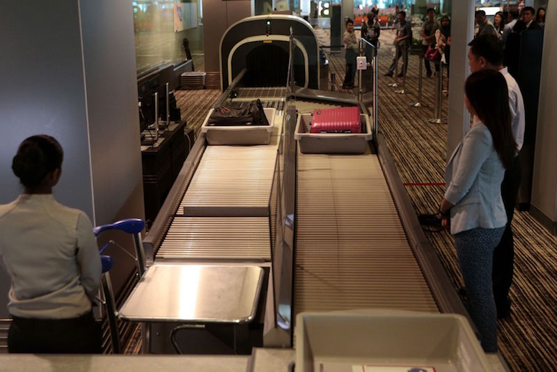 A demonstration of a new hand luggage screening system being trialled at Changi Airport’s Terminal 3. It allows two passengers to simultaneously scan their hand-carry luggage. — TODAY pic
