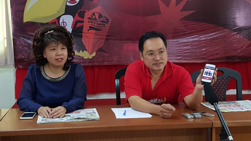 Chong Chieng Jen asking reporters to listen to a speech by Ooi on his handphone at a press conference today. Seen at left is Pending state lawmaker Violet Yong April 9, 2016. u00e2u20acu201d Picture by Sulok Tawie