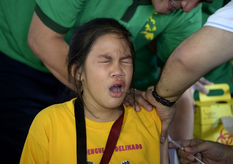 A student grimaces as a nurse administers the anti-dengue vaccine at Parang Elementary School in Marikina, west of Manila, April 4, 2016. u00e2u20acu201d AFP picn