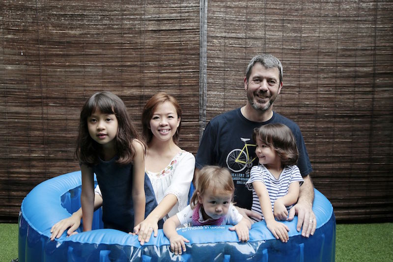 Diana Chen, her husband Ashley Robinson and their children Jemimah, nine, Samuel, 16 months, and Matilda, four, pose for a photo in the inflatable birthing tub that Chen used. u00e2u20acu201d TODAY picn