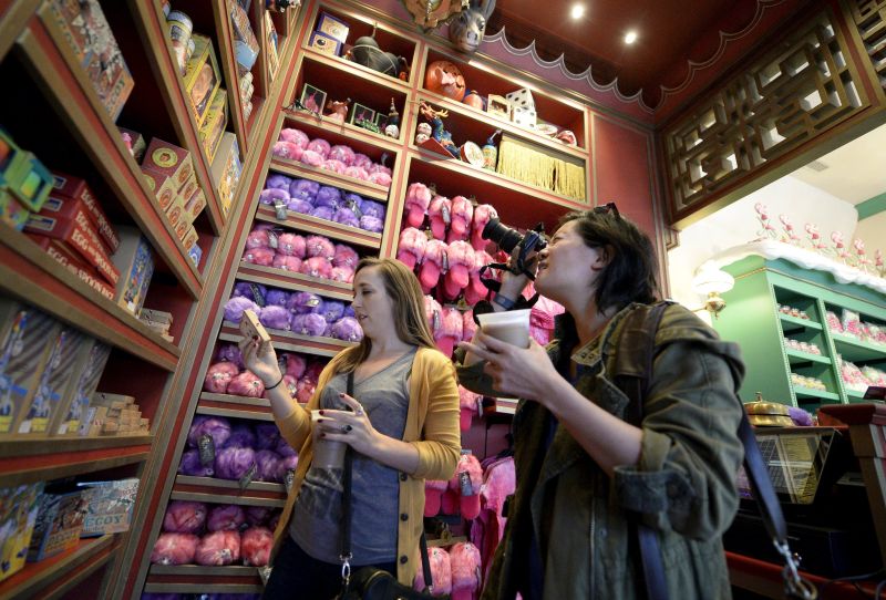 Guests look at a display of candy inside the Honeydukes sweets shop in Hogsmeade Village during a soft opening and media tour of u00e2u20acu02dcThe Wizarding World of Harry Potteru00e2u20acu2122 theme park at the Universal Studios Hollywood in Los Angeles, California. u00e2u20acu2022 Reuter