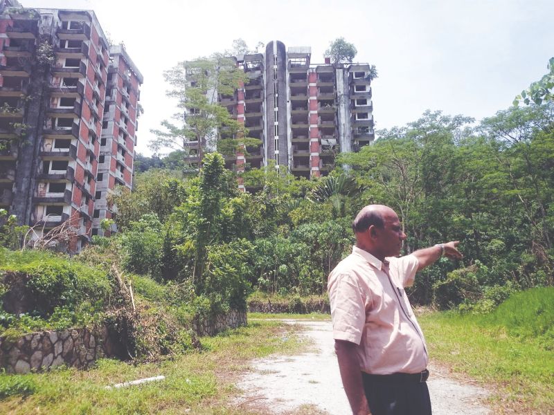 Civil engineer Selvanayagam Nagalingam points at the site where Block One of the Highland Towers used to stand. u00e2u20acu2022 Malay Mail pic