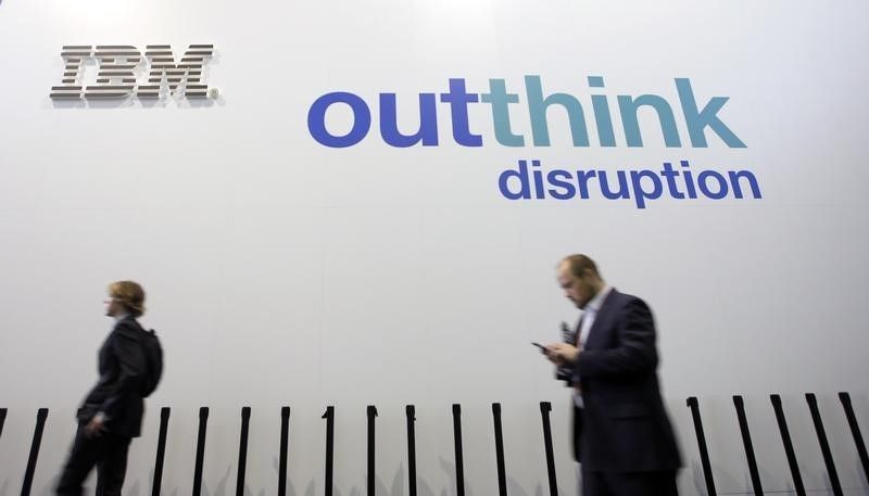 People walk past an IBM logo during the Mobile World Congress in Barcelona February 25, 2016. u00e2u20acu201d Reuters