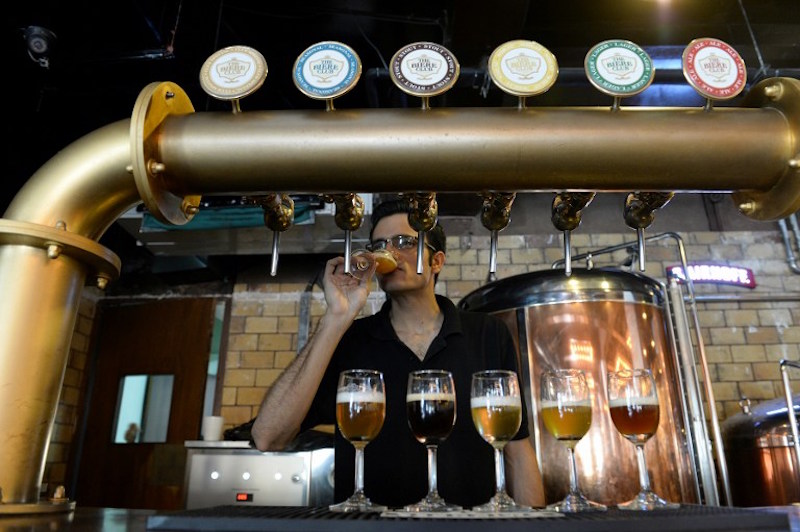 Head Brewer at The Biere Club, Rohit Jairam Parwani, tastes craft beer at the microbrewery in Bangalore March 30, 2016. u00e2u20acu201d AFP picn