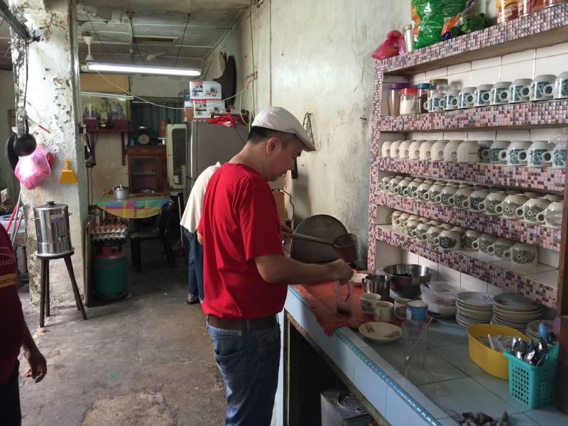 Tan Jeng Seow preparing coffee at the coffee shop his grandfather started at Hutton Lane.