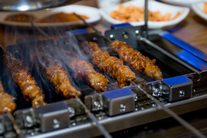 Lamb skewers are cooked at the table at Songhwa Yanggochi near Konkuk University in Seoul. u00e2u20acu2022 Picture by Jo Turner/Zester Daily