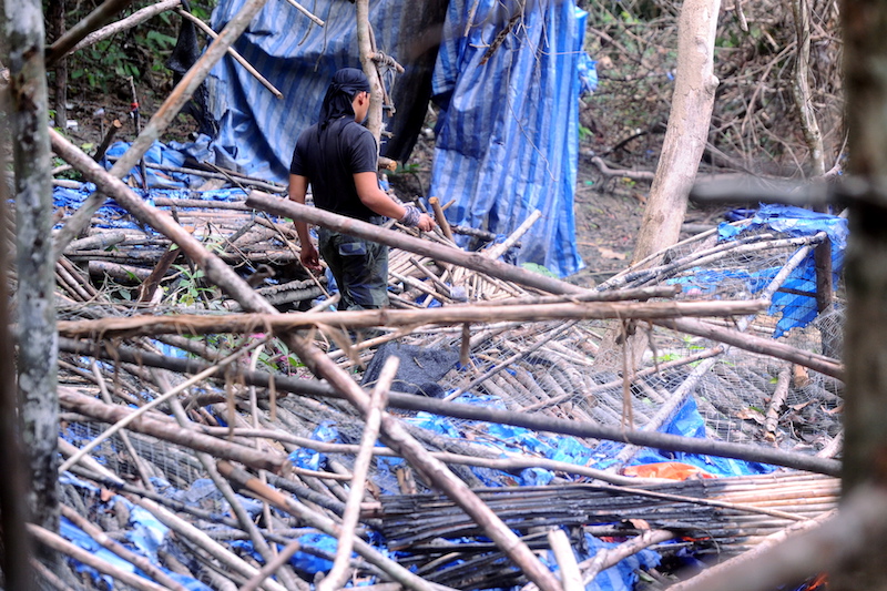 A soldier walks among the ruins of an immigrant camp found near the Malaysia-Thai border last May. u00e2u20acu201d Picture by Azinuddin Ghazali n