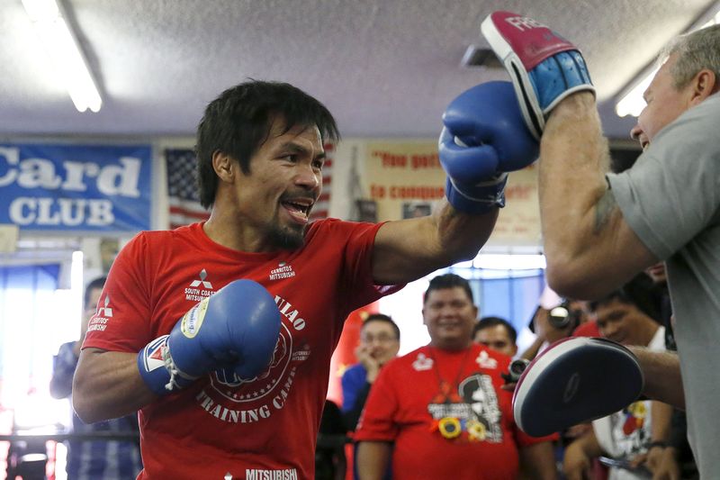Boxer Manny Pacquiao (left) works out with his trainer Freddie Roach ahead of his bout with Tim Bradley, in Hollywood March 30, 2016. u00e2u20acu201d Reuters pic