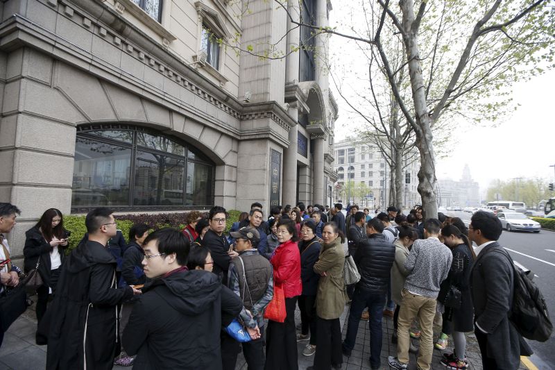 Investors gather at the office of Shanghai investment firm Zhongjin Capital Management in Shanghai, April 7, 2016. REUTERS/Aly Song