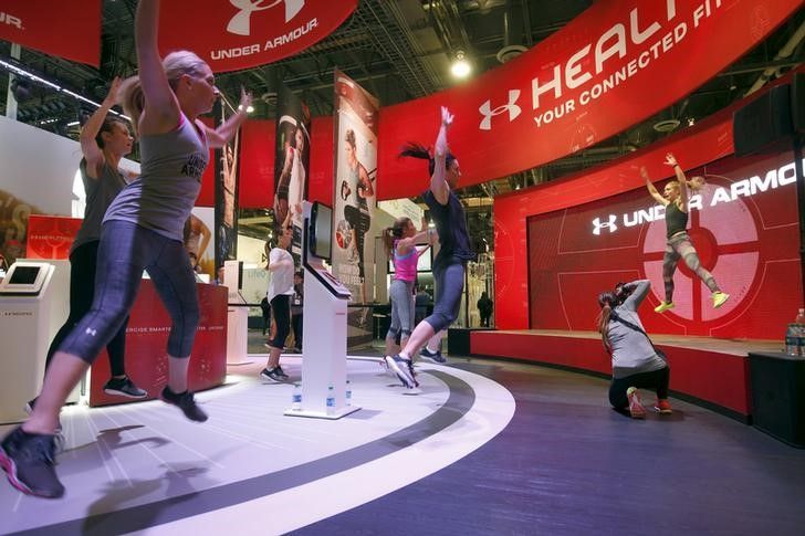 People work out at the Under Armour booth as the company promotes the Health Box, a Connected Fitness system, 2016 CES trade show in Las Vegas January 8, 2016. REUTERS/Steve Marcus