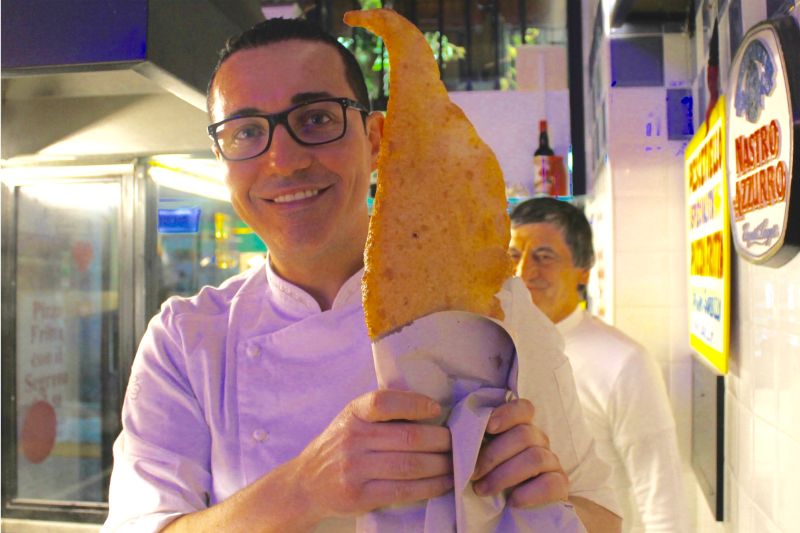 Gino Sorbillo, Italy's famed pizzaiuolo, holds a finished pizza fritta. — Picture courtesy of Francine Segan