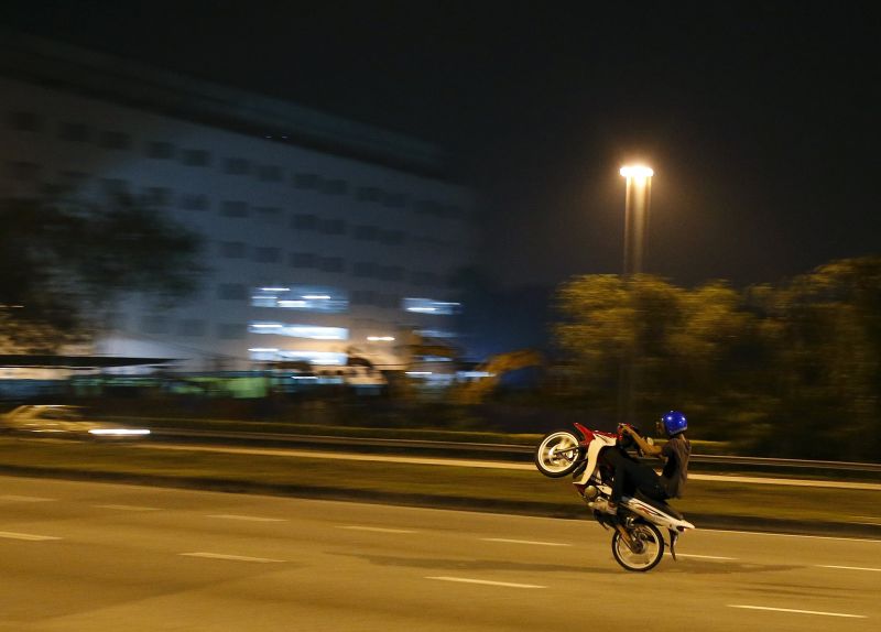 A motorcyclist performs a wheelie on a highway in Kuala Lumpur. u00e2u20acu2022 Reuters pic