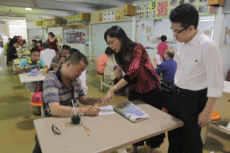 Teresa Kok and Liew Chin Tong speak with those who turned up for the signature campaign in Kg Baru Salak Selatan in Kuala Lumpur, April 17, 2016. u00e2u20acu201d Picture by Yusof Mat Isa
