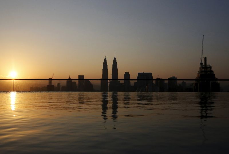 The Petronas Twin Towers are reflected in a swimming pool as the sun rises over Kuala Lumpur, Malaysia, April 1, 2016. u00e2u20acu2022 Reuters pic