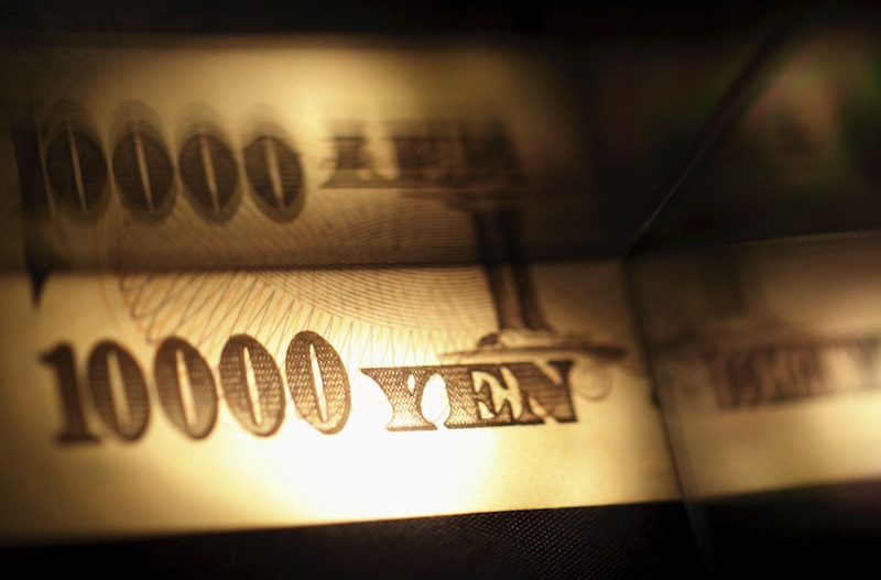 Light is cast on a Japanese 10,000 yen note as it's reflected in a plastic board in Tokyo, in this February 28, 2013 picture illustration. u00e2u20acu201d Reuters pic